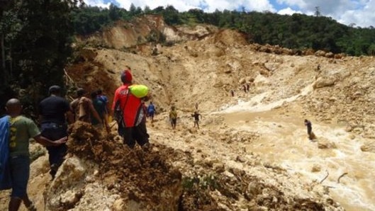 People gather at the site of a landslide in Papua New Guinea's Southern Highlands on January 25, 2012.