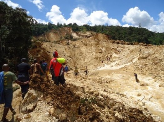People gather at the site of a landslide in Papua New Guinea's Southern Highlands on January 25, 2012.