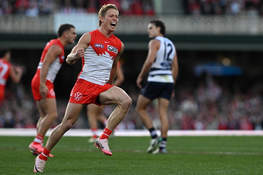 Isaac Heeney celebrates a Swans AFL goal against the Cats.
