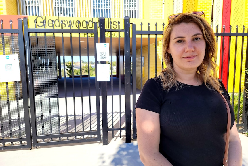 A woman stood at a school gate