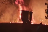A truck engulfed in flames.