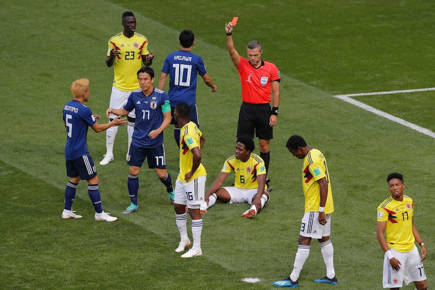 Referee shows a red card to Colombian player Carlos Sanchez