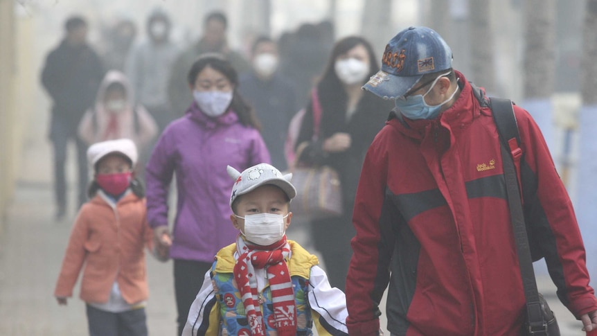 Chinese residents wearing face masks on a street in Harbin