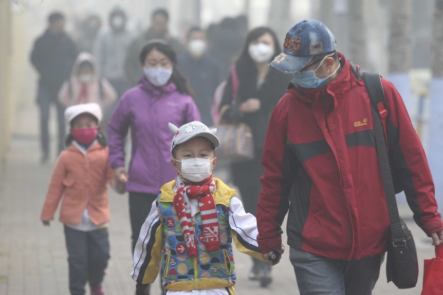 Chinese residents wearing face masks on a street in Harbin