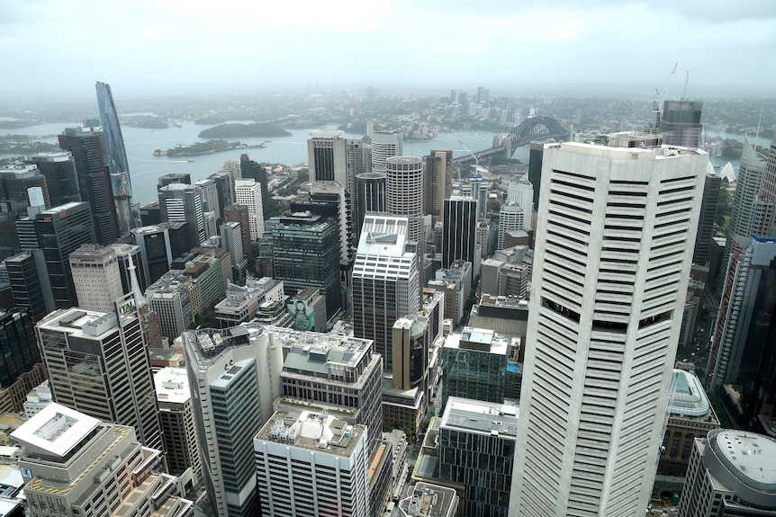 Tall office buildings of varying heights seen from above on a slightly cloudy day.