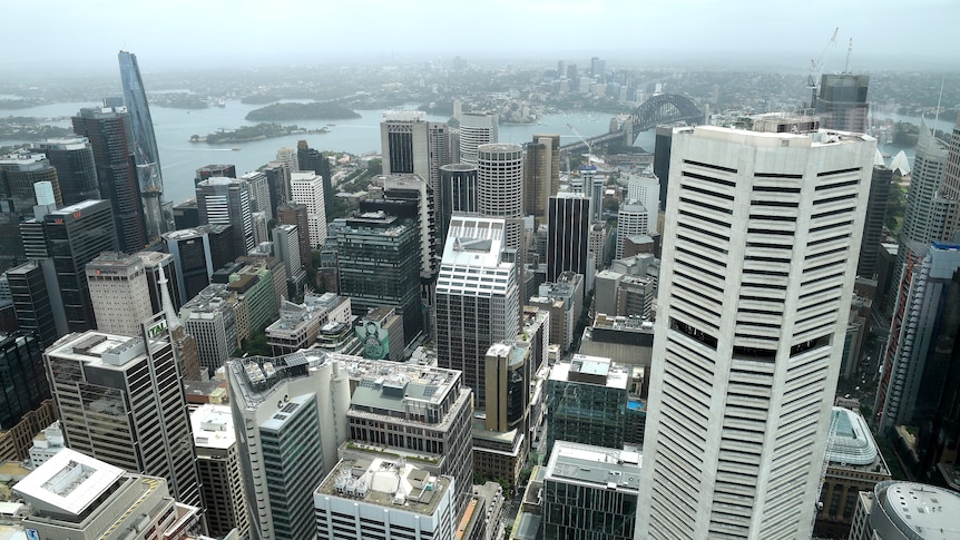 Tall office buildings of varying heights seen from above on a slightly cloudy day.