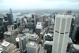 Tall office buildings of varying heights seen from above on a slightly cloudy day.