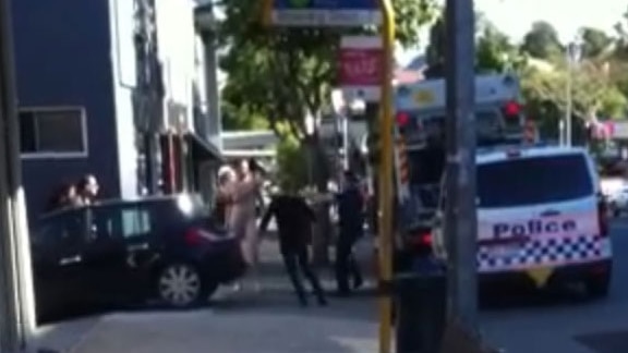 Police officers with a naked man at West End in Brisbane on August 29, 2014, who allegedly bashed a female police officer.