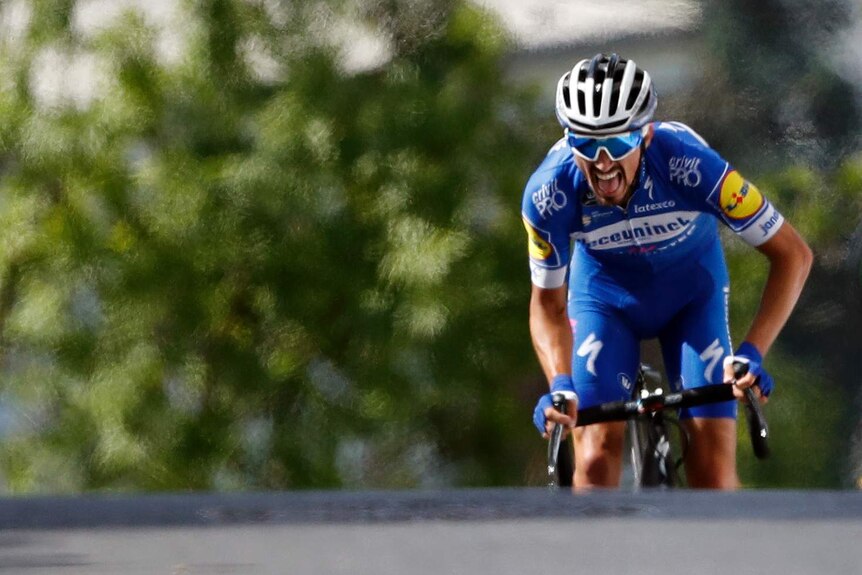 Julian Alaphilippe rides up the final hill with his mouth open