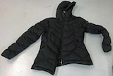 A black puffer jacket lining flat on the floor