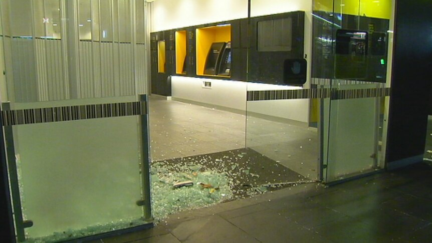 Shattered glass in the doorway of a Commonwealth Bank in Melbourne after a driver crashed into the front door.