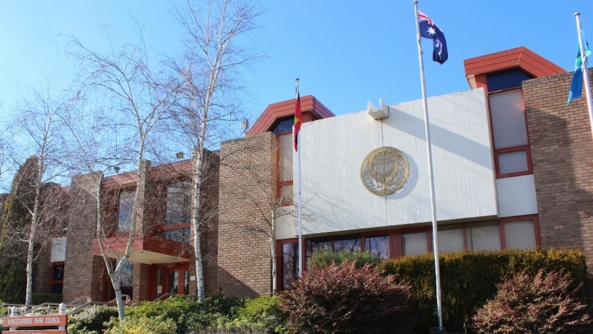Front of Wingecarribee Council chambers with a Australian flag flying on flag pole.