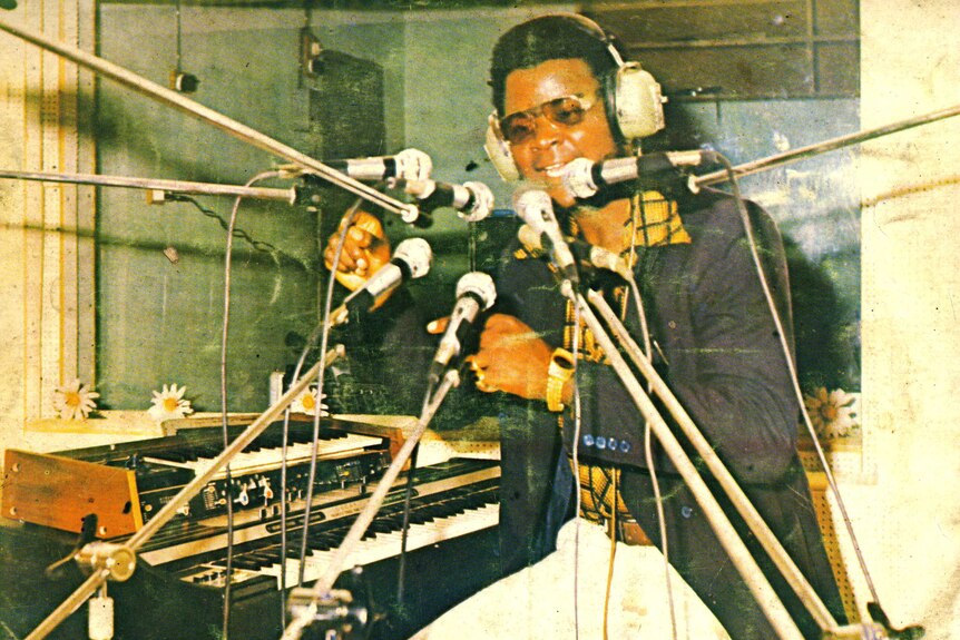 Nigerian synth musician William Onyeabor sings into microphones