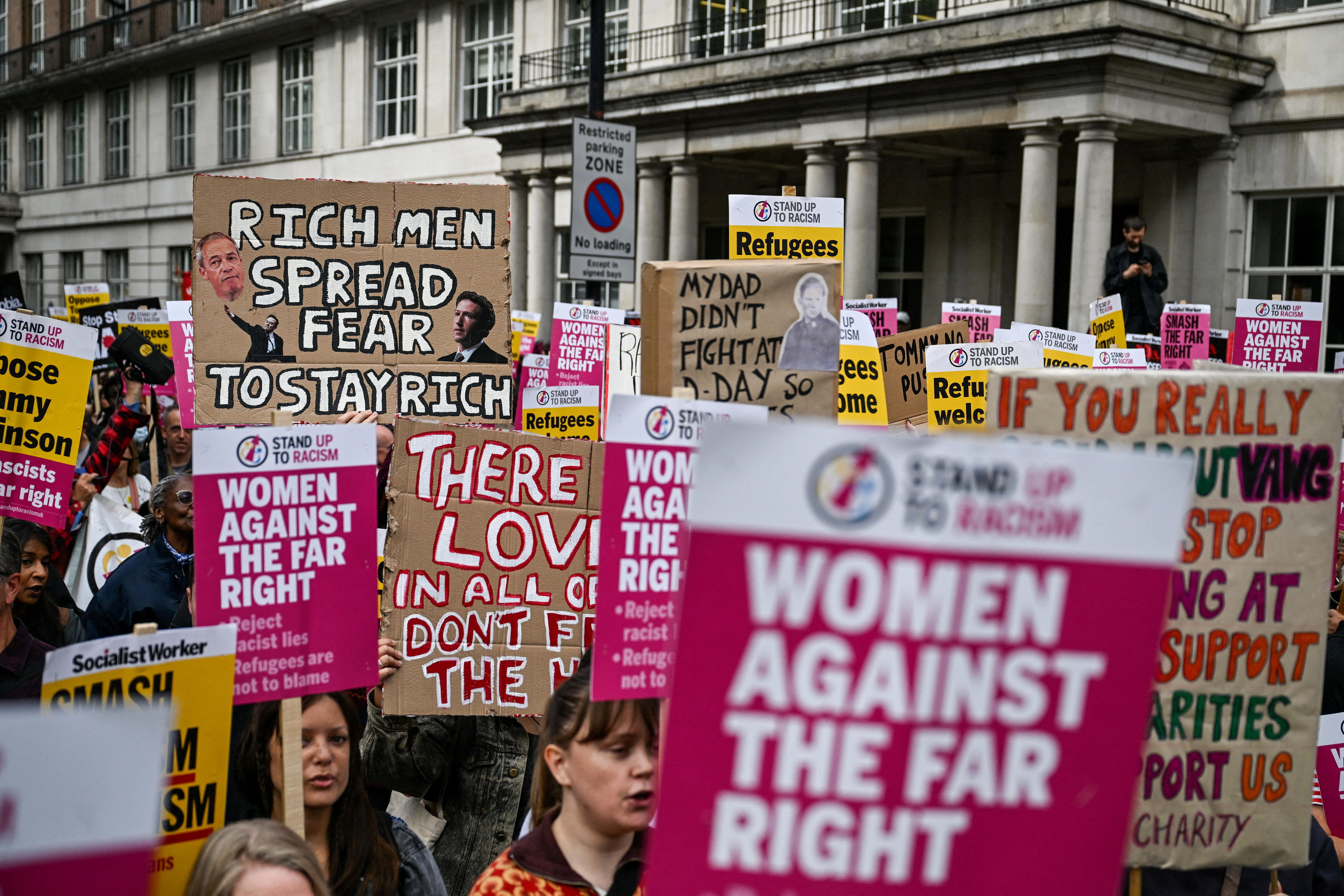 Counter protestors hold signs against the far right.