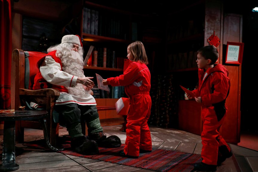 Santa Claus talks to children in Finland.