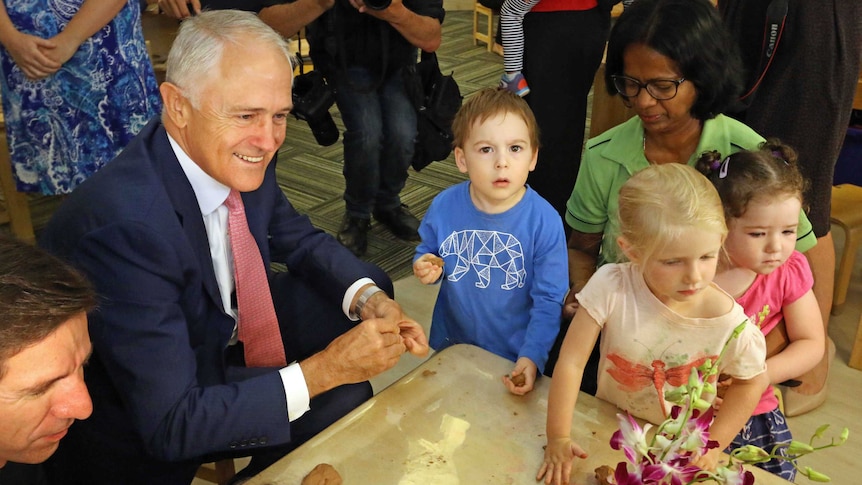 Malcolm Turnbull playing with children at a daycare centre.