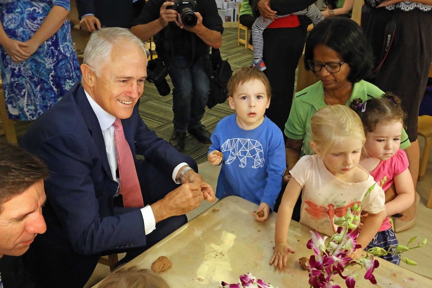 Malcolm Turnbull playing with children at a daycare centre.