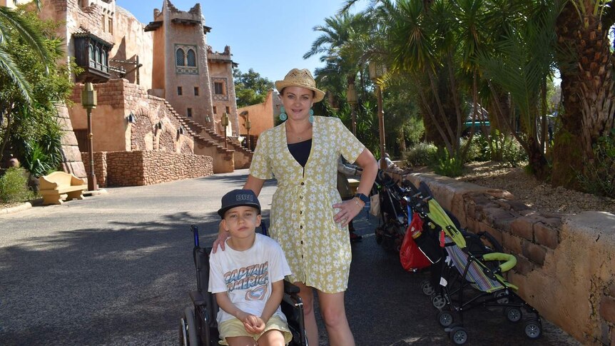 Sarah Thomas and her son in a wheelchair looking at camera.