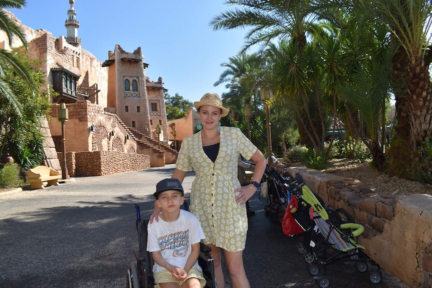 Sarah Thomas and her son in a wheelchair looking at camera.