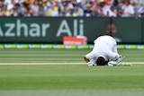 Pakistan's Azhar Ali kisses the ground after scoring a century at the MCG