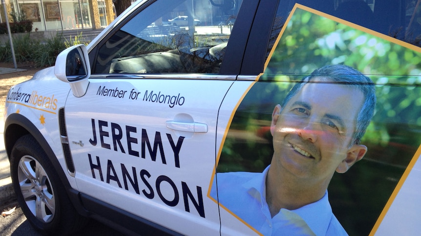 Jeremy Hanson has been driving around his private car, emblazoned with his picture and slogan.
