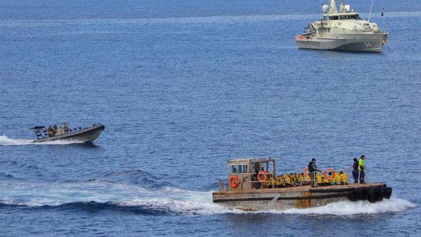 Asylum seekers are taken to the jetty on Christmas Island for processing