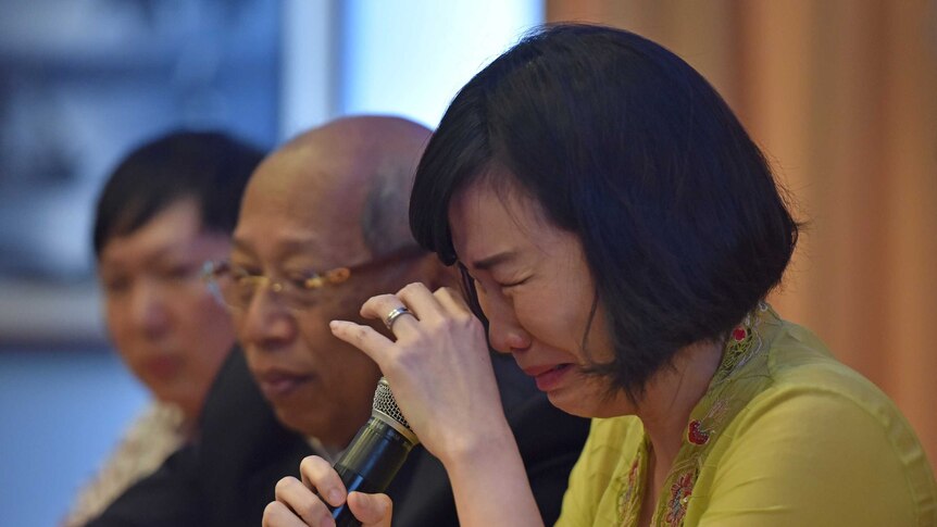 The wife of jailed former governor Basuki Tjahaja Purnama, known as Ahok, weeps during a news conference.