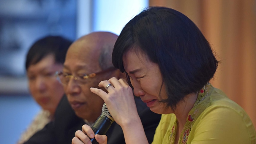 The wife of jailed former governor Basuki Tjahaja Purnama, known as Ahok, weeps during a news conference.