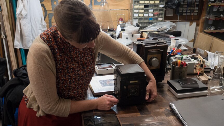 Aurelia adjusting a camera on her bench.