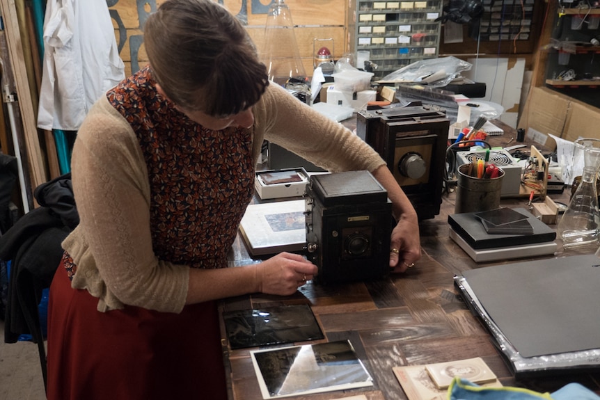 Aurelia adjusting a camera on her bench.