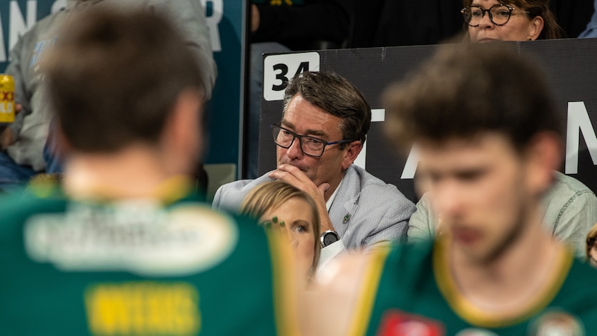 Simon Brookhouse sits by the court, looking pensive.