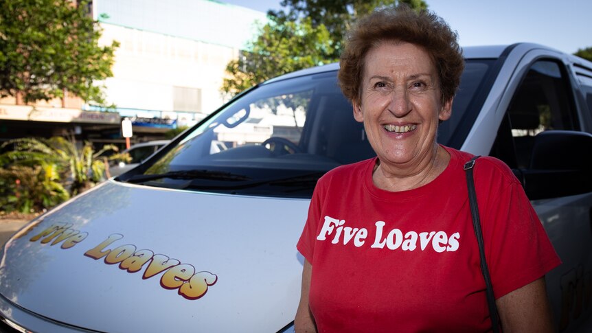 Woman in Five Loaves t-shirt next to Five Loaves van