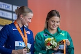 Nina Kennedy and Katie Moon look at medals