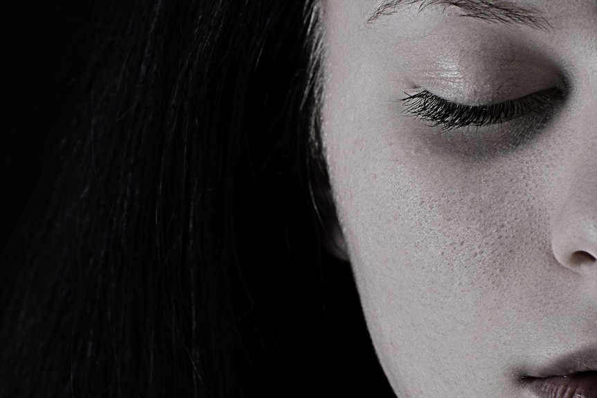 A close up of a face in black and white