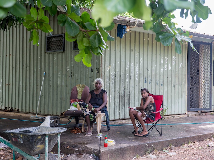 Mindy and her niece's daughter sit on the patio of their One Mile Dam home