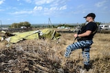 Pro-Russian rebel guards MH17 crash site