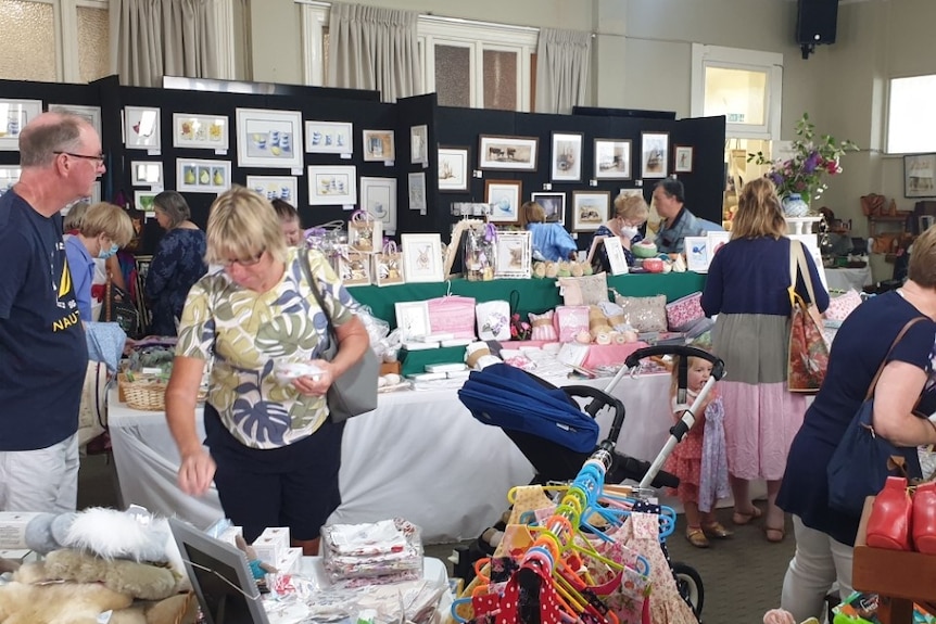 Photo of people shopping at an art market.