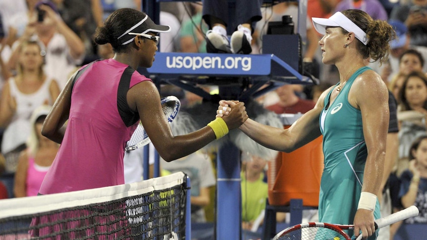 Sam Stosur (right) shakes hands with US player Victoria Duval