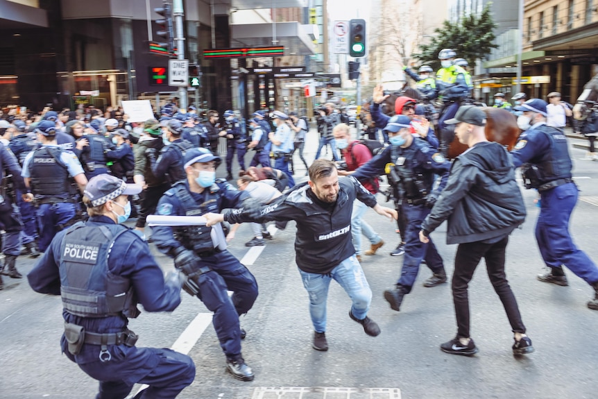 NSW Police circle a protester