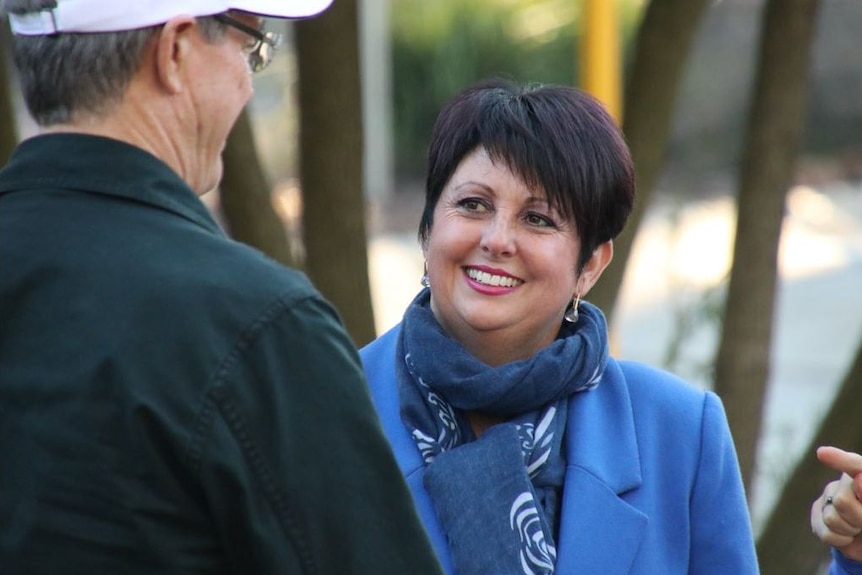 Liberal candidate for Darling Range Alyssa Hayden talking to party leader Mike Nahan and smiling wearing a blue jacket.