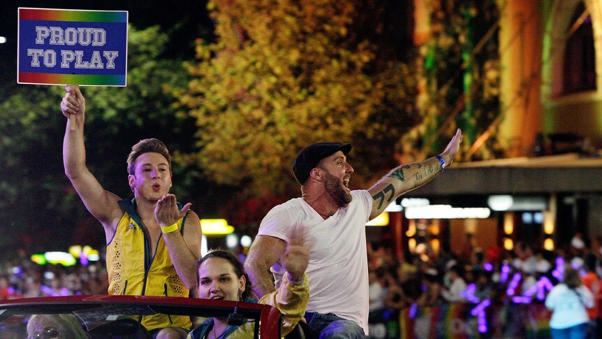 Olympian Matthew Mitcham (L) takes part in the 2015 Sydney Gay and Lesbian Mardi Gras parade.