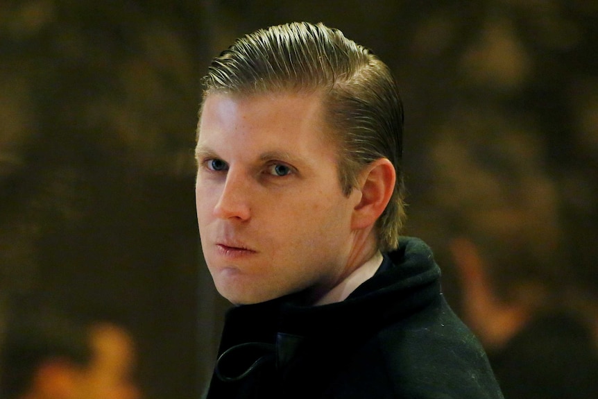 Head shot of Eric Trump pursing his lips with slicked back hair.