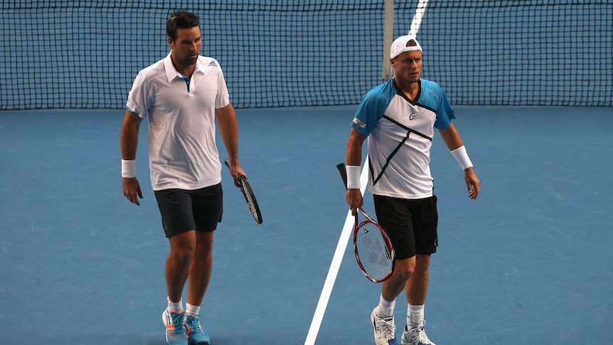 Early exit ... Lleyton Hewitt (R) and Pat Rafter during their doubles match