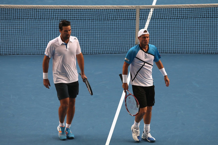 Lleyton Hewitt and Pat Rafter on court.