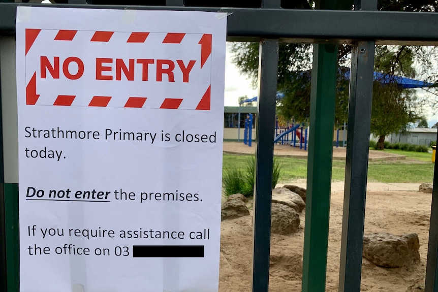 A sign that says "No Entry - Strathmore Primary is closed today" on the gate outside the school.