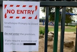 A sign that says "No Entry - Strathmore Primary is closed today" on the gate outside the school.