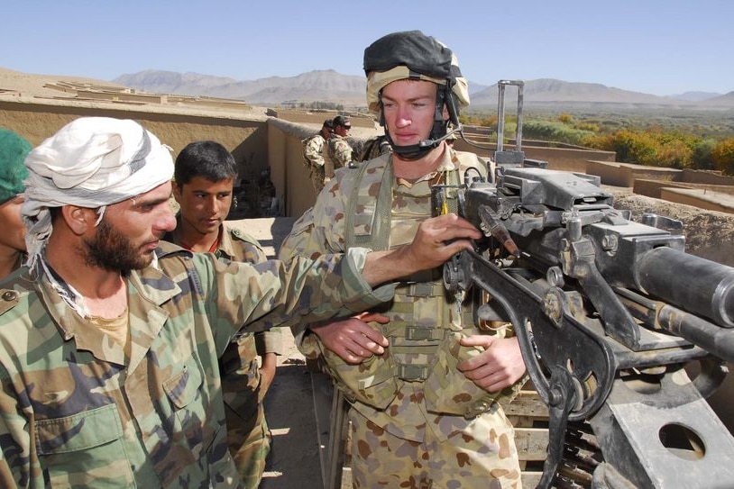 An Afghani soldier and an Australian soldier share their expertise during a training operation