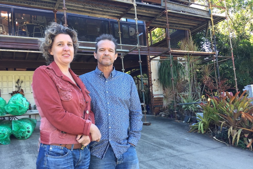 Kristel and Rod Taylor in front of their cyclone damaged house