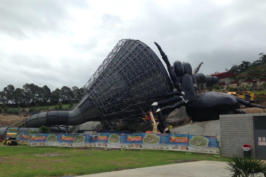 A giant funnel web spider sculpture next to a water slide, in a public water park at Jamberoo NSW.