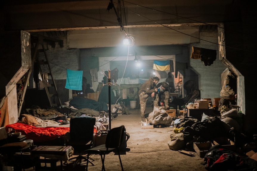 Soldiers shelter in makeshift living qaurters set up along an underground corridor.